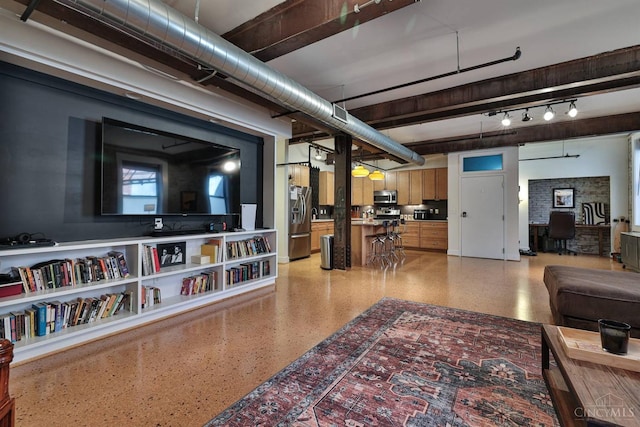 living area with dark aggregate flooring