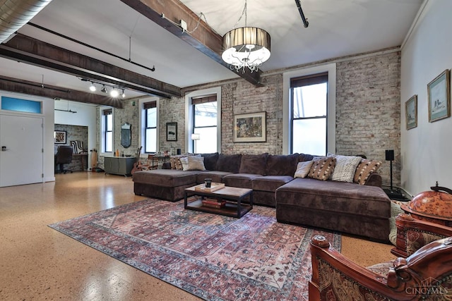 living area with speckle patterned floor, a chandelier, and beamed ceiling