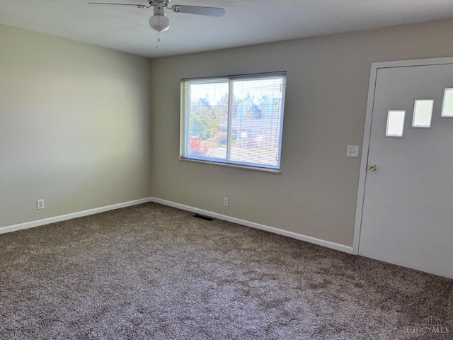 carpeted entrance foyer with ceiling fan and baseboards