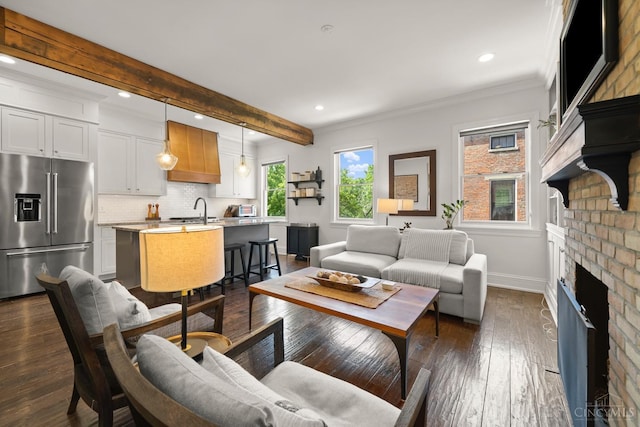 living room featuring baseboards, a fireplace, dark wood-style floors, recessed lighting, and ornamental molding