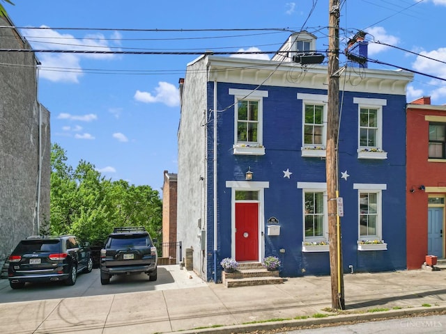 view of front of property featuring entry steps and brick siding