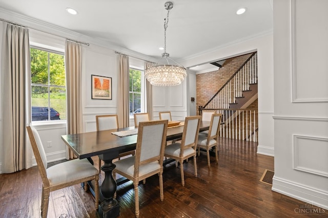 dining room with a chandelier, stairs, ornamental molding, plenty of natural light, and dark wood finished floors