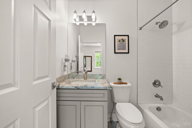 bathroom featuring toilet, washtub / shower combination, and vanity