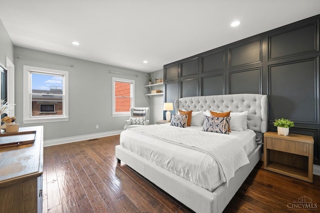 bedroom featuring multiple windows, baseboards, dark wood-style floors, and recessed lighting