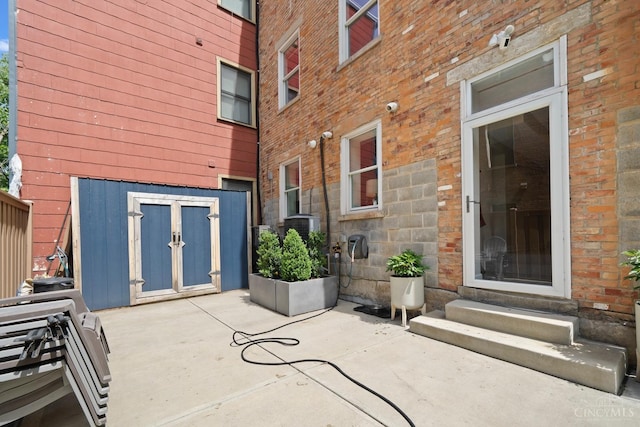 entrance to property with a patio and brick siding