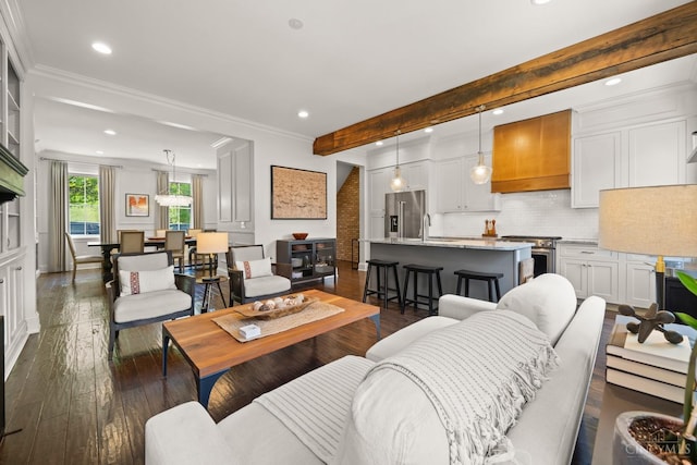 living area with recessed lighting, dark wood-type flooring, ornamental molding, and beam ceiling