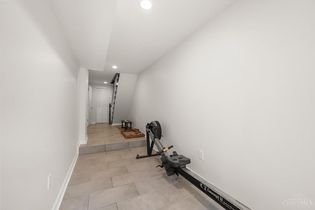 hallway with recessed lighting, baseboards, and light tile patterned floors