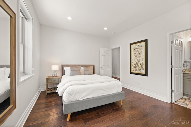 bedroom with hardwood / wood-style floors, baseboards, recessed lighting, and ensuite bath