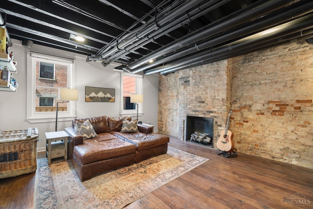 living room with wood finished floors and a fireplace