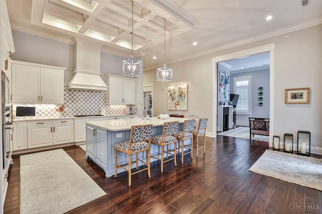 kitchen featuring stovetop, dark wood-style flooring, recessed lighting, a chandelier, and light countertops