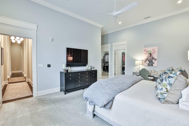 bedroom with ornamental molding, carpet floors, baseboards, a walk in closet, and recessed lighting