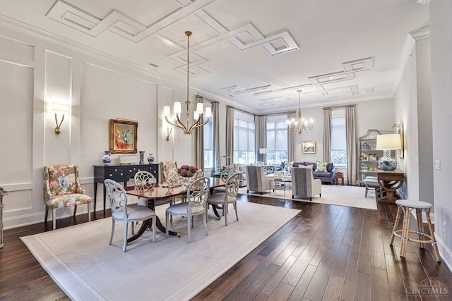 dining space featuring a chandelier, dark wood finished floors, and ornamental molding