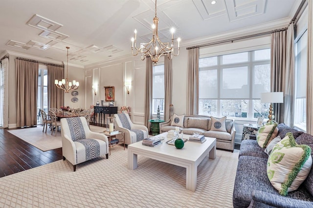 living room with a chandelier, crown molding, and dark wood finished floors