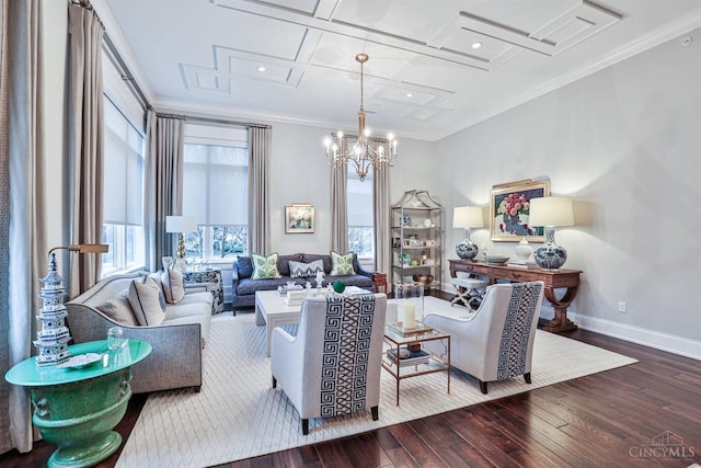 living area with wood-type flooring, ornamental molding, baseboards, coffered ceiling, and a chandelier