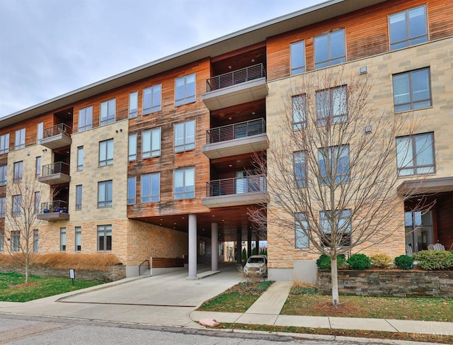 view of apartment building / complex with a carport