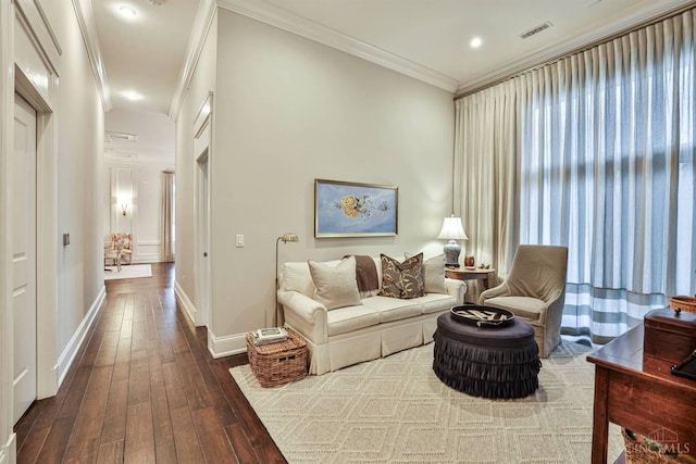 living area with dark wood-type flooring, crown molding, baseboards, and recessed lighting