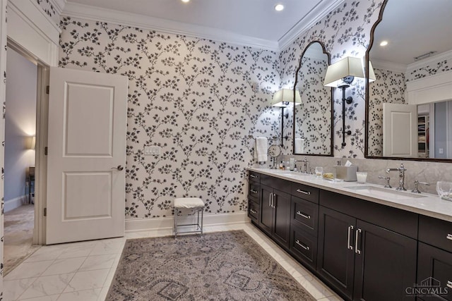 full bathroom featuring crown molding, wallpapered walls, recessed lighting, double vanity, and marble finish floors