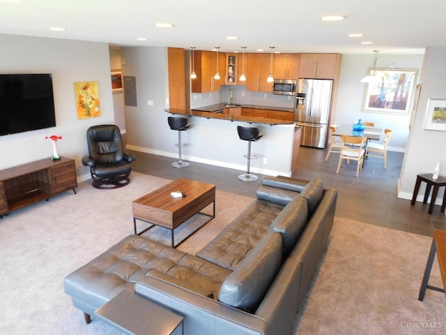 living area with baseboards and recessed lighting