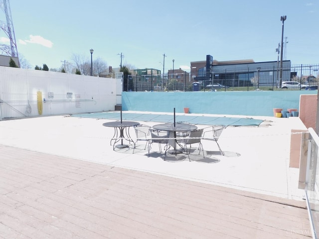 view of swimming pool featuring fence
