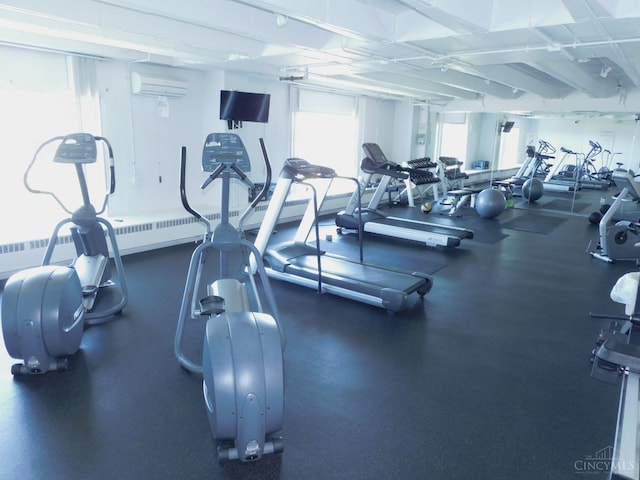 exercise room featuring an AC wall unit