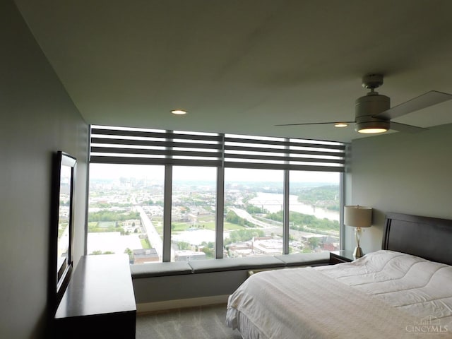bedroom with a view of city, recessed lighting, ceiling fan, and carpet flooring