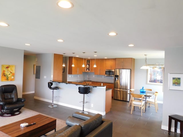 living area featuring baseboards, recessed lighting, and electric panel