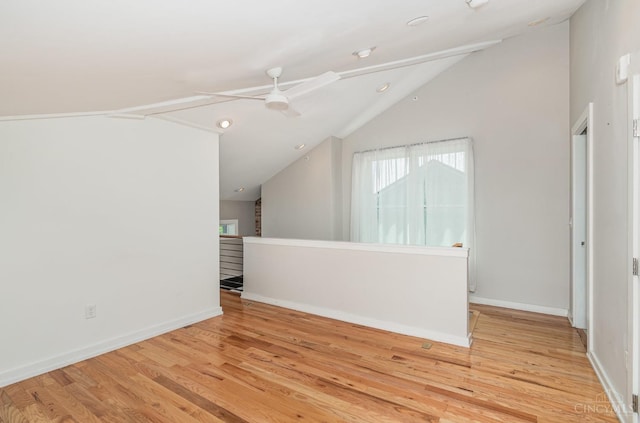 additional living space featuring a ceiling fan, light wood finished floors, vaulted ceiling, baseboards, and recessed lighting