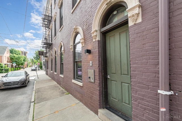 entrance to property with brick siding