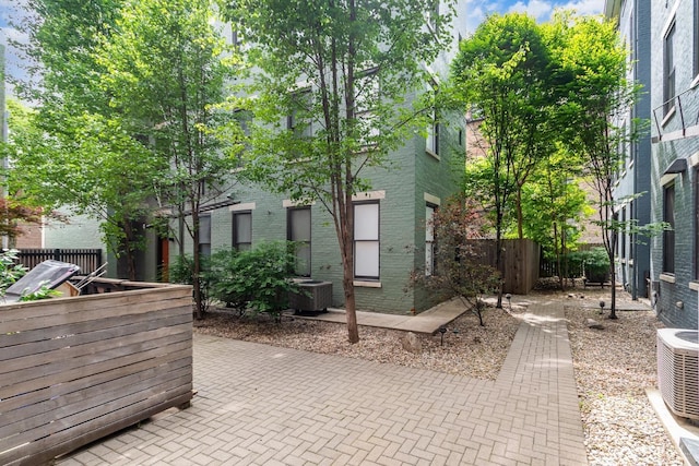 view of patio with fence and central AC unit