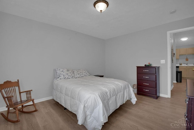 1740 Piper Ln Unit 206, Centerville, OH 45440 - bedroom with light wood-style flooring, baseboards, and a sink