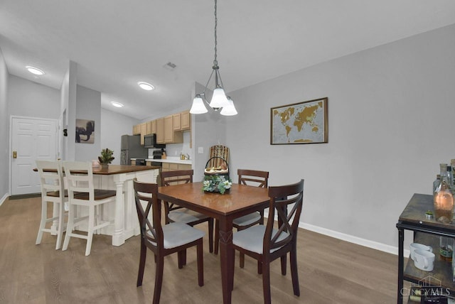 1740 Piper Ln Unit 206, Centerville, OH 45440 - dining space featuring wood finished floors, baseboards, and lofted ceiling