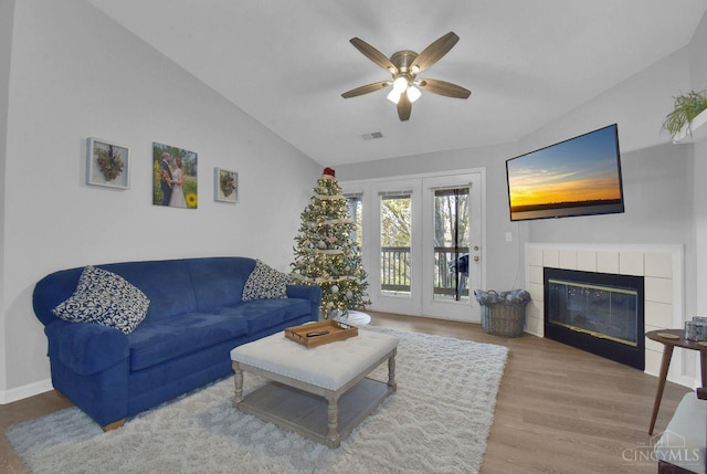 1740 Piper Ln Unit 206, Centerville, OH 45440 - living room featuring wood finished floors, ceiling fan, a tiled fireplace, and lofted ceiling