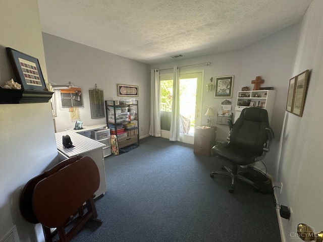 office space with a textured ceiling and carpet