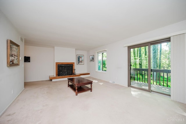 5672 Crooked Tree Ln, Miami Twp, OH 45150 - unfurnished living room featuring a fireplace with raised hearth and carpet