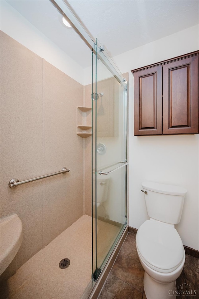 5672 Crooked Tree Ln, Miami Twp, OH 45150 - bathroom featuring a stall shower, toilet, and baseboards