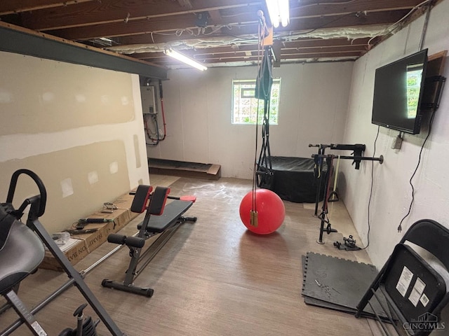 exercise room featuring wood finished floors
