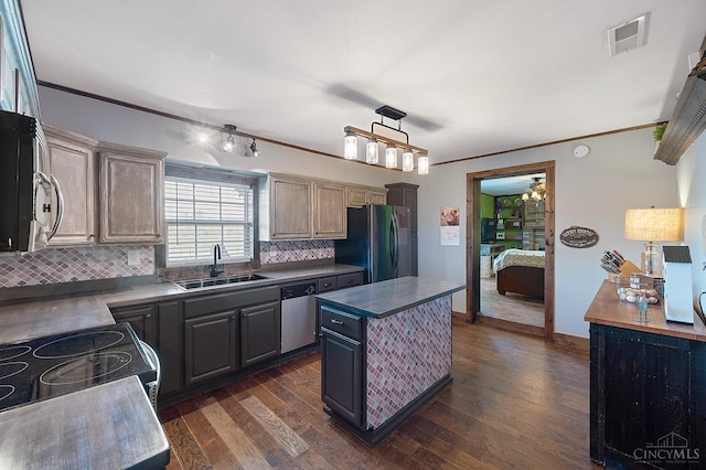 6241 Marathon Edenton Rd, Wayne Twp, OH 45107 - kitchen featuring appliances with stainless steel finishes, backsplash, dark wood finished floors, a kitchen island, and ornamental molding