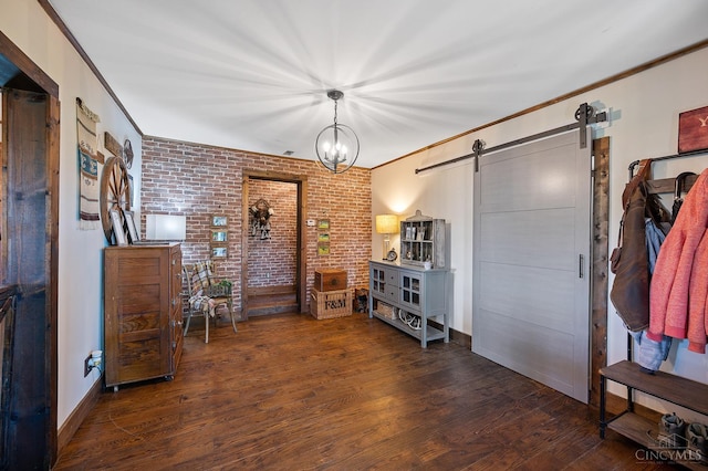 6241 Marathon Edenton Rd, Wayne Twp, OH 45107 - entryway featuring a barn door, brick wall, wood finished floors, and crown molding