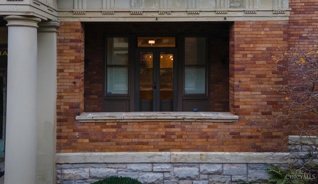 entrance to property with brick siding and french doors