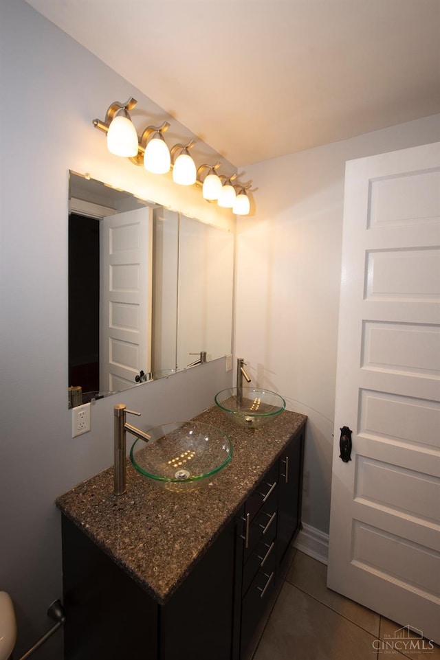 bathroom with tile patterned flooring and double vanity