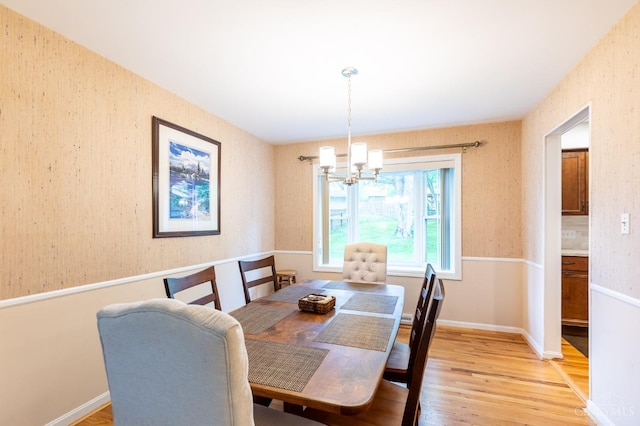 dining space featuring a chandelier and light wood-style floors