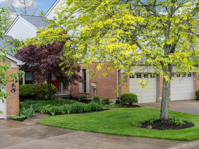 2869 Phaeton Ln, Deerfield Twp, OH 45039 - obstructed view of property featuring driveway, brick siding, a front lawn, and an attached garage