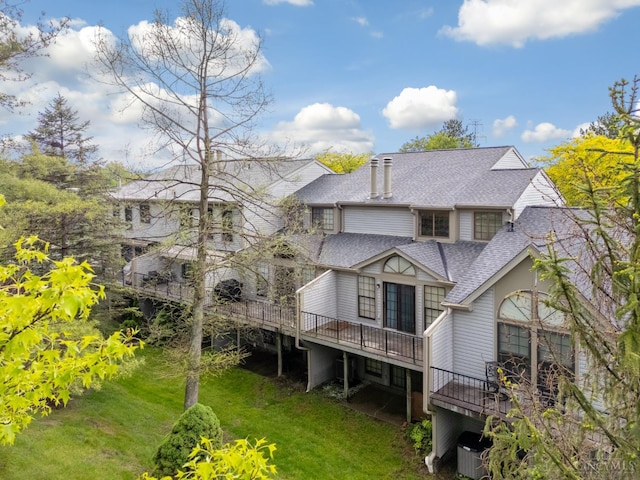 2869 Phaeton Ln, Deerfield Twp, OH 45039 - rear view of house with a shingled roof, a wooden deck, a lawn, a chimney, and central AC unit