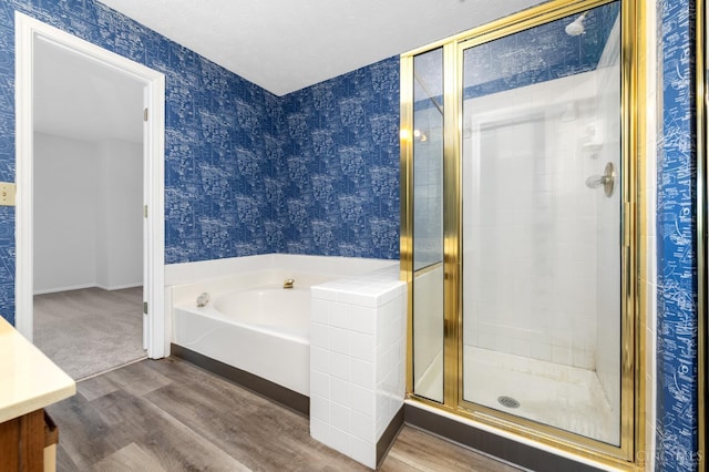 2869 Phaeton Ln, Deerfield Twp, OH 45039 - full bath featuring wallpapered walls, wood finished floors, a garden tub, and a stall shower