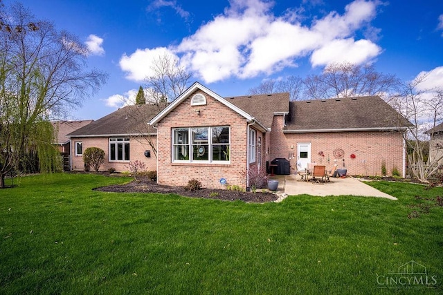 1668 Nichole Ct, Hamilton, OH 45013 - rear view of house featuring a patio, brick siding, a lawn, and a shingled roof