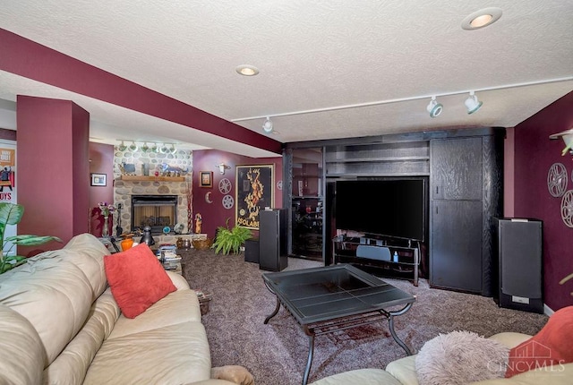 1668 Nichole Ct, Hamilton, OH 45013 - carpeted living room with rail lighting, a textured ceiling, and a fireplace