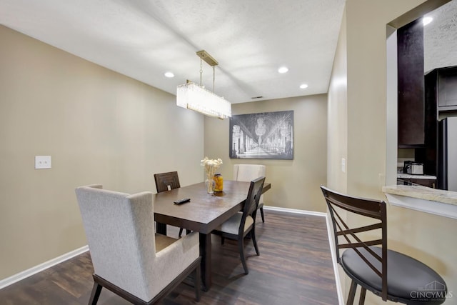dining space with dark wood-style floors, baseboards, and recessed lighting