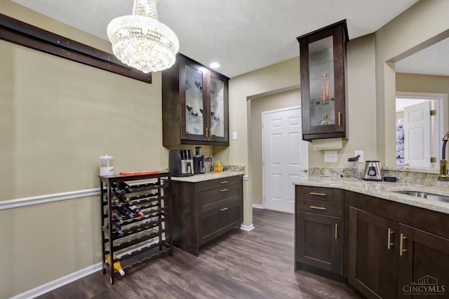 indoor dry bar with dark wood finished floors, baseboards, a chandelier, and recessed lighting