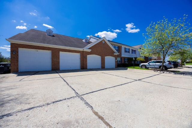 view of side of property with brick siding and an attached garage