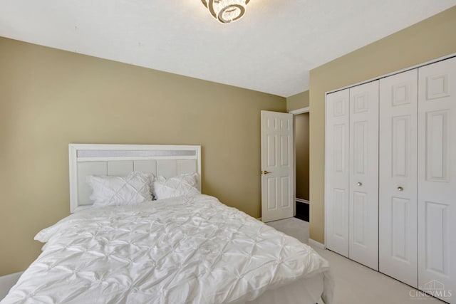 bedroom with light colored carpet and a closet